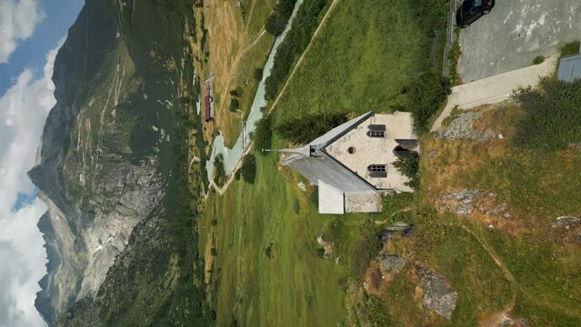 Aerial View Of Anglican Chapel Gletsch Near Grimselstrasse. Vertical Video, Parallax Shot
