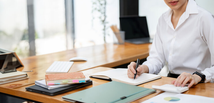 Businesswoman or accountant working Financial investment on calculator, calculate, analyze business and marketing growth on financial document data graph, Accounting, Economic, commercial concept.