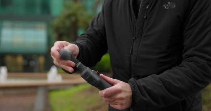 Unfolding Osmo Mobile modern gimbal stabilizer and mounting cell phone