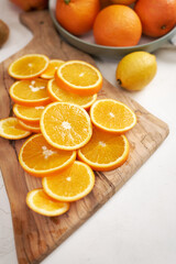 Fresh Sliced organic oranges on wooden cutting board