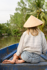Female tourist on boat in Mekong River Delta, Vietnam