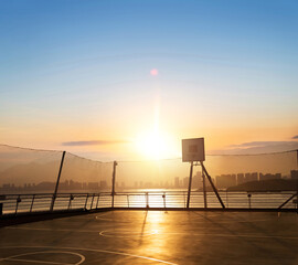 Outside basketball court on the roof with net around