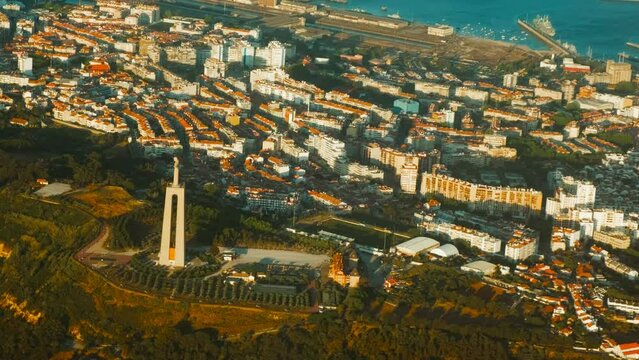 Aerial view of Almada, Christ the King monument, Lisbon, Portugal, River Tagus and urban sprawl, with statue dominating skyline