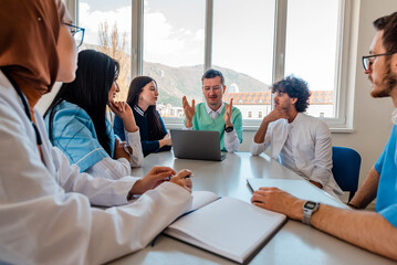 A medical team of doctors discussing at a meeting in the conference room.