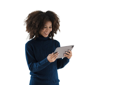 Image of a young African woman, a company worker in casual wear, smiling and holding a digital tablet, standing over white background.