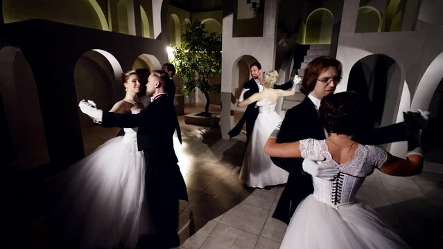 happy people dancing in ballroom, romantic dancing pairs dancing by classic music in royal palace