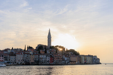 Fototapeta na wymiar Tower of St. Euphemia Church in Rovinj on the peninsula with the picturesque old town in the light of the sunset