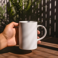 Obraz premium Mockup empty person hand holding a white blank coffee mug&nbsp;in cafe&nbsp;beautiful light and shadow