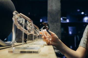 Shopping a new digital device. Happy beautiful woman choosing a smart watch in tech store