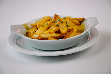 A plate of french fries with sauce