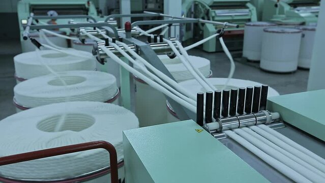 Textile factory equipment for the production of yarns. Factory for the production of cotton yarns, machines for spinning production. Textile factory.