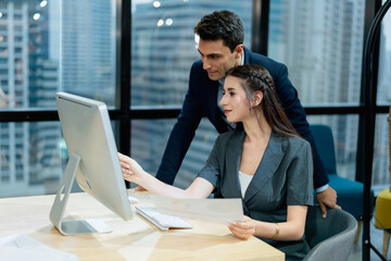 Professional Mentor Explaining Job Details to Young Female Colleague Workplace Learning and Career Development with Laptop.