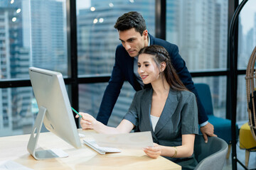 Professional Mentor Explaining Job Details to Young Female Colleague Workplace Learning and Career Development with Laptop.