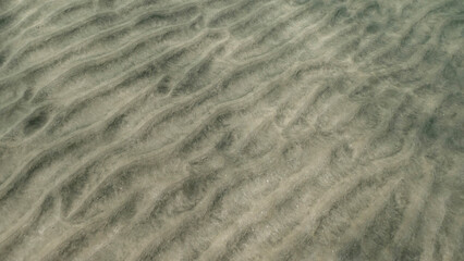Sandy bottom covered with sand hills,  Natural background from the underwater depth, Red sea, Egypt