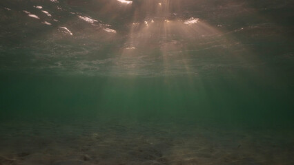 Low angle wide shot sun rays penetrating surface of water in the morning time, Underwater light creates beautiful veil, consisting of sunlight in the morning time, Red sea, Egypt