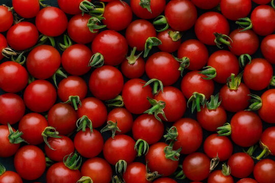 Closeup view on red charry tomatoes background. Vegetable backdrop
