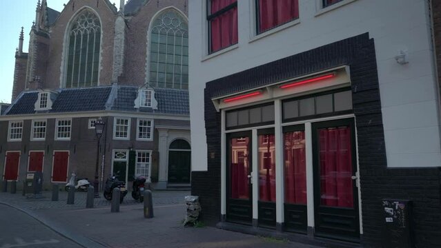 Building reflection on glass show windows of Amsterdam Red Light District De Wallen