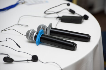 two microphones on a round table.