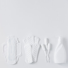 Tampons, feminine sanitary pads and liquid intimate soap on a white background