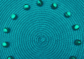 Green emerald spiral round straw background with green balls. Place for text