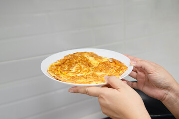 Chef is making fried egg in kitchen, famous everyday life food for Thai Asian people