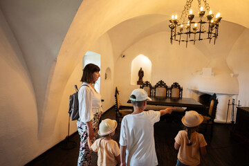 Mother and kids walking in the hall of the castle.
