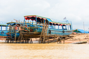 Wooden boats raised up on stilts on the Siem Reap river, Cambodia