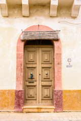 Traditional wooden door and bamboo screen to keep out heat.