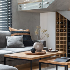 Stylish composition of living room interior with corner grey sofa, green velvet armchair, coffee...