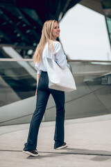 Long-haired young woman in office clothes looking confident