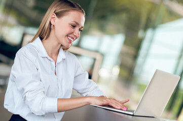 Cute young manager working on a laptop