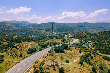 Telecommunication tower of cellular in countryside highway with car traffic, Cellular in road trip...