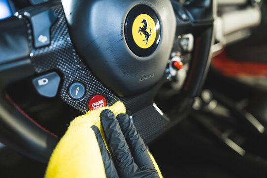 17.05.2023. Warsaw, Poland. cleaning Ferrari's steering wheel with a yellow cloth. High quality photo
