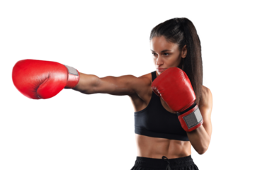 Kickboxing woman in activewear and red kickboxing gloves on a transparent background performing a martial arts kick. Sport exercise, fitness workout.