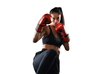 Kickboxing woman in activewear and red kickboxing gloves on a transparent background performing a martial arts kick. Sport exercise, fitness workout.