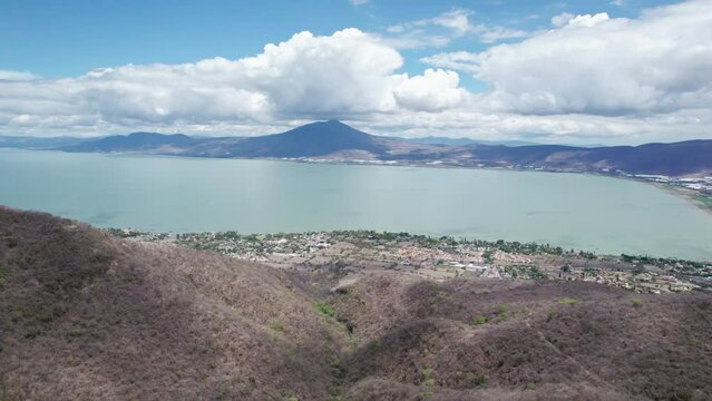 This compelling drone footage reveals a stunning aerial journey from the mountains to the vast, serene expanse of Lake Chapala in Jalisco, Mexico