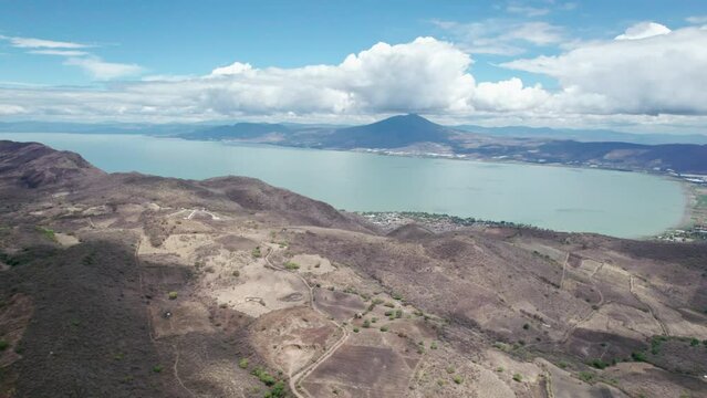This compelling drone footage reveals a stunning aerial journey from the mountains to the vast, serene expanse of Lake Chapala in Jalisco, Mexico