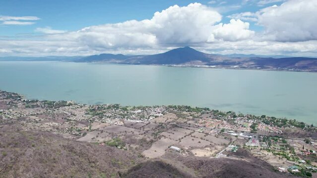 This compelling drone footage reveals a stunning aerial journey from the mountains to the vast, serene expanse of Lake Chapala in Jalisco, Mexico
