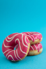 Fototapeta na wymiar Pink donuts on a blue background