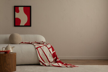 Warm and cozy living room interior with red mock up poster frame, copy space, stylish beige sofa,...