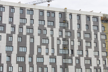 Close-up facade of a large modern city building under construction