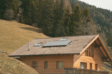 Solar panels on the roof. Concept of using photovoltaics in rural areas and countryside for a sustainable future. Modern house with an alternative source of electrical energy.
