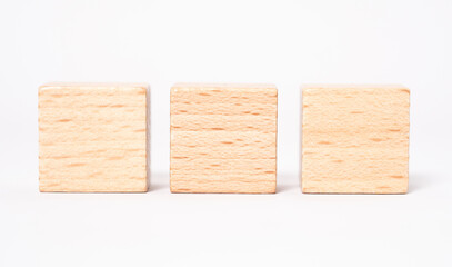 Three empty wooden cubes with place for letters or an mages