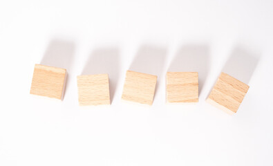 Five empty wooden cubes with place for letters