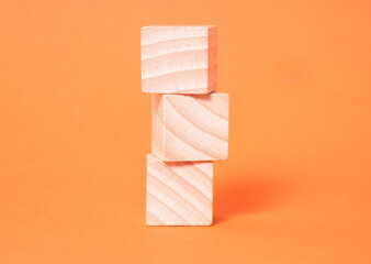Three empty wooden cubes with place for letters