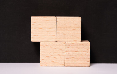 Four empty wooden cubes with place for letters or images