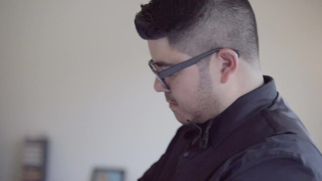 Groom putting on cufflinks on his wedding day. Winter Wedding. Married.