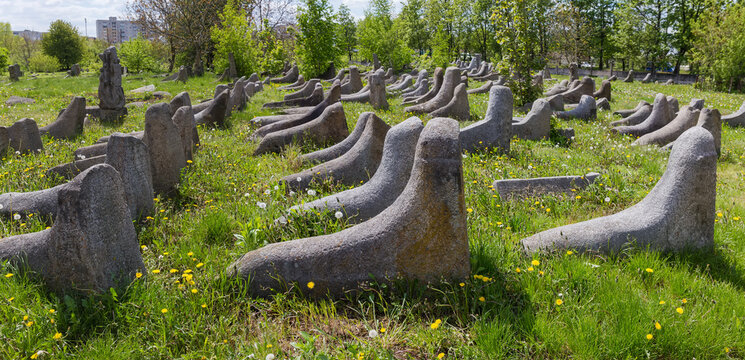 Old stone tombstones on ancient Jewish cemetery in sunny day
