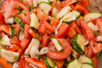 Salad of tomatoes, cucumbers and red bell peppers, top view