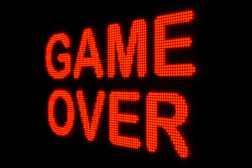 Game Over, close-up led sign. Dark screen with the text "game over" in red glowing letters. Leisure games, finishing, end, final game, challenge, video game. 3D illustration